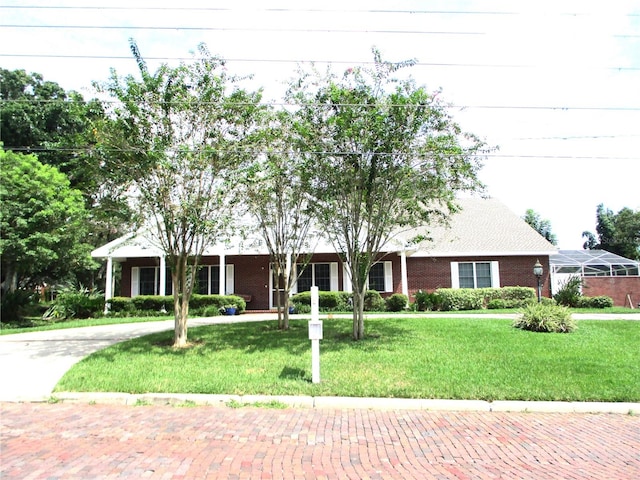 view of front of property featuring a front lawn and brick siding