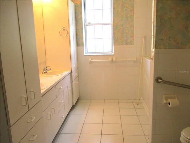 bathroom featuring tile walls, toilet, vanity, and tile patterned floors