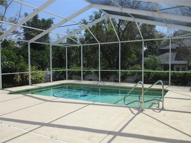 outdoor pool featuring a lanai and a patio area