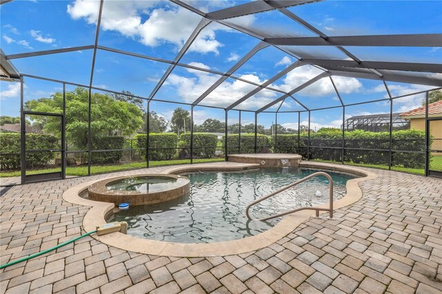 view of swimming pool with a patio, an in ground hot tub, and glass enclosure