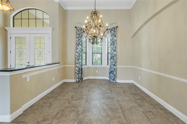 unfurnished dining area with ornamental molding and a notable chandelier