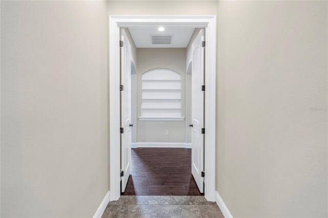 hallway with wood-type flooring