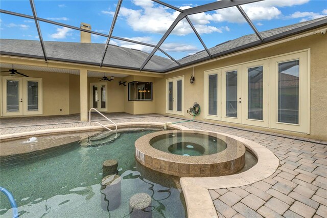 view of swimming pool featuring a lanai, a patio area, an in ground hot tub, ceiling fan, and french doors