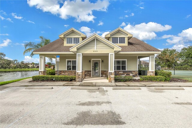 craftsman-style home with a water view and a porch