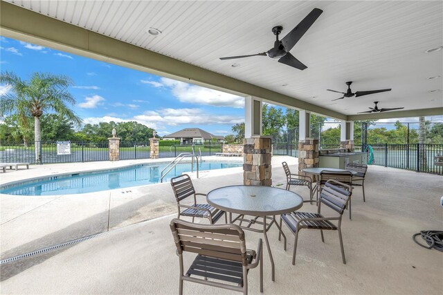 view of pool featuring ceiling fan and a patio