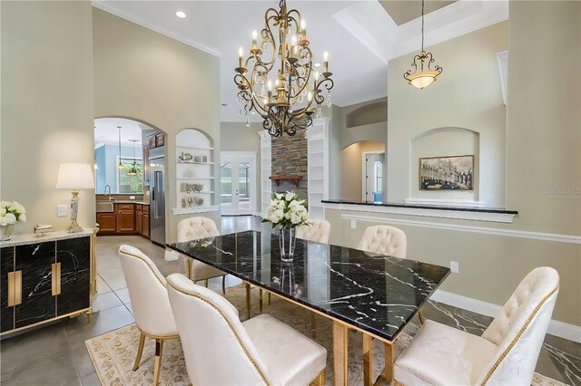 dining area with ornamental molding, a towering ceiling, a chandelier, and tile patterned flooring