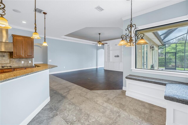 kitchen with pendant lighting, hardwood / wood-style flooring, ceiling fan with notable chandelier, and ornamental molding