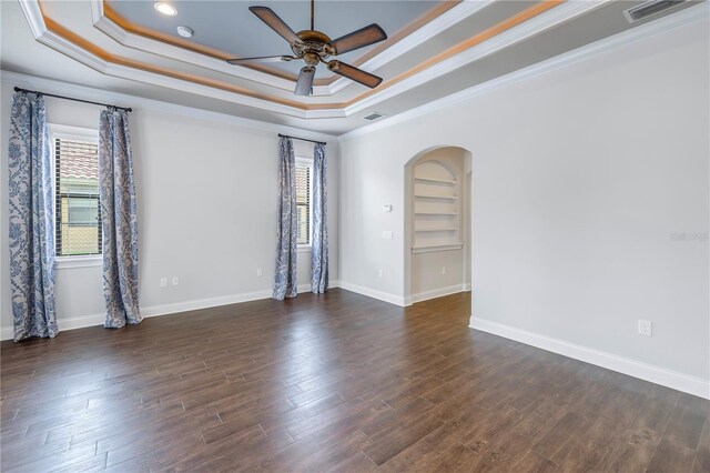 unfurnished room with crown molding, dark hardwood / wood-style floors, and ceiling fan