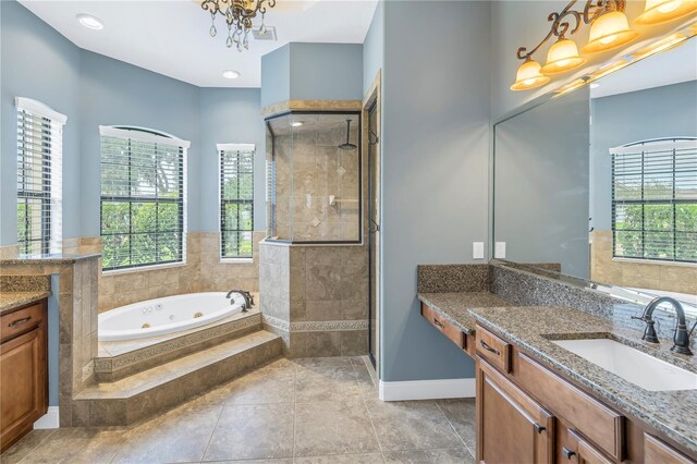 bathroom featuring a notable chandelier, tile patterned flooring, independent shower and bath, and vanity