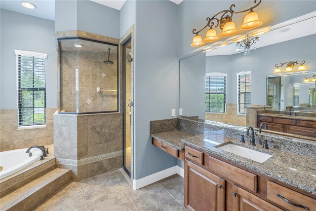 bathroom featuring plus walk in shower, tile patterned floors, and vanity