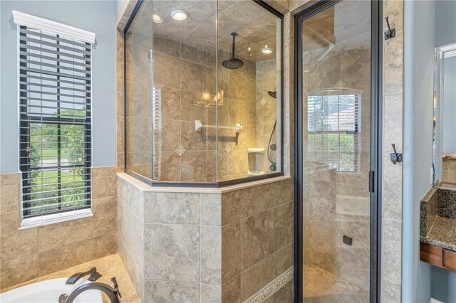 bathroom featuring shower with separate bathtub and vanity