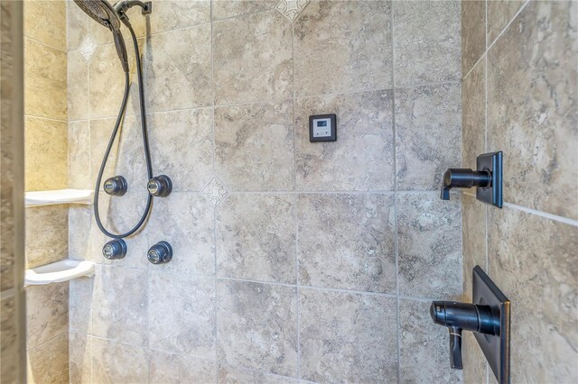 interior details featuring tiled shower