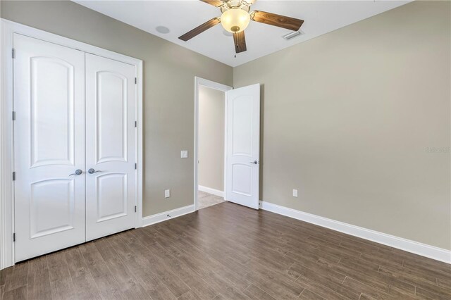 unfurnished bedroom featuring a closet, ceiling fan, and dark hardwood / wood-style floors