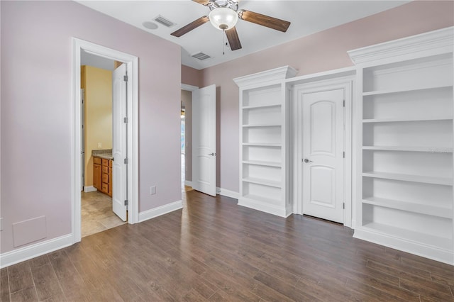 unfurnished bedroom featuring ceiling fan, connected bathroom, and dark hardwood / wood-style floors