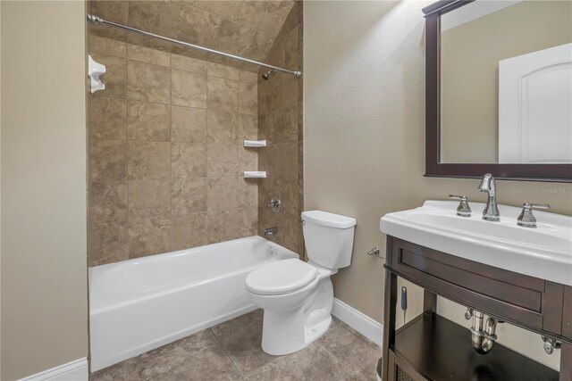 full bathroom featuring vanity, tiled shower / bath combo, toilet, and tile patterned flooring