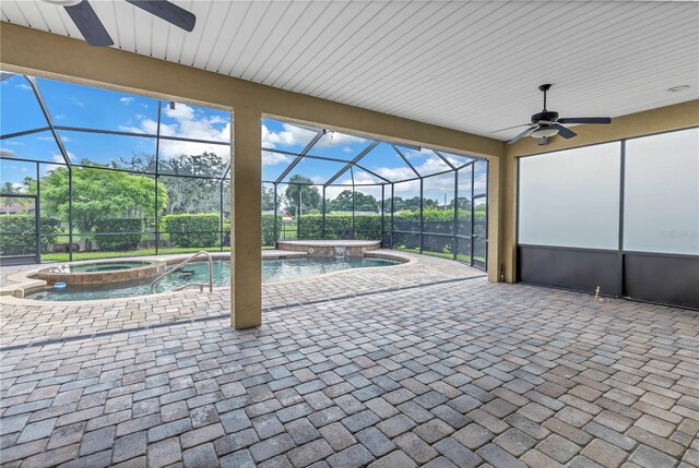 view of patio / terrace with a pool with hot tub, a lanai, ceiling fan, and pool water feature