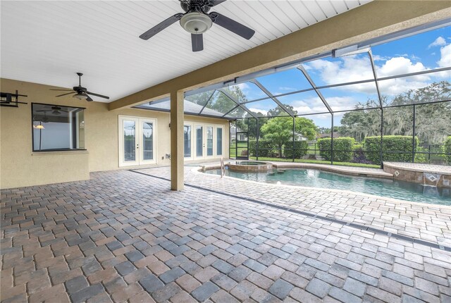 view of pool featuring a patio, glass enclosure, ceiling fan, and an in ground hot tub