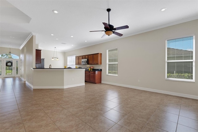 interior space featuring light tile patterned floors, stainless steel appliances, ceiling fan, decorative light fixtures, and ornamental molding