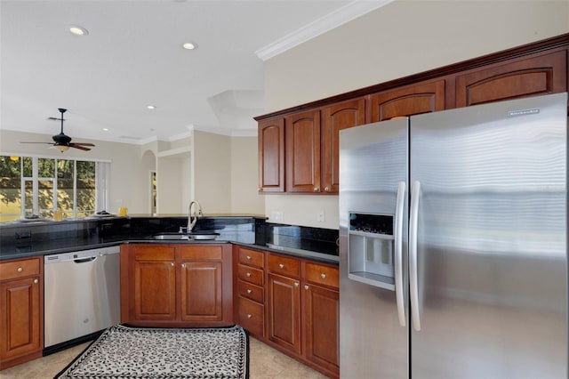 kitchen featuring ceiling fan, ornamental molding, appliances with stainless steel finishes, and sink