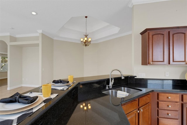 kitchen with an inviting chandelier, pendant lighting, crown molding, and sink