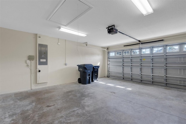 garage with a garage door opener and electric panel