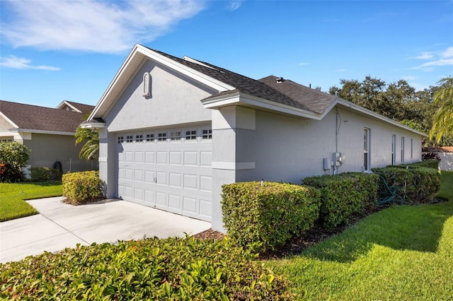 view of home's exterior featuring a lawn and a garage