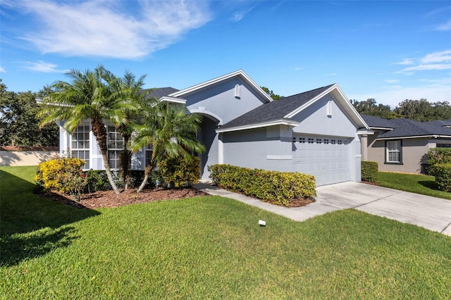 single story home featuring a garage and a front lawn