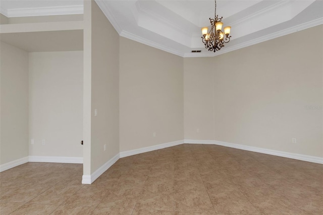 tiled empty room featuring crown molding, a tray ceiling, and a notable chandelier