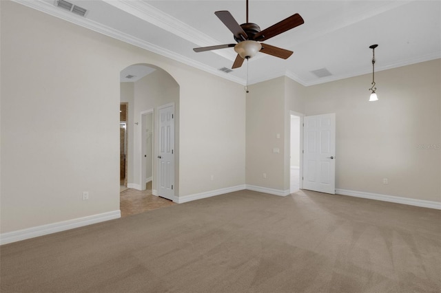 unfurnished room with ornamental molding, light carpet, and ceiling fan