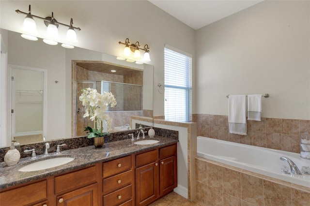 bathroom with shower with separate bathtub, vanity, and tile patterned floors