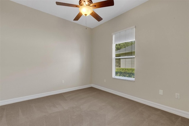 carpeted spare room with ceiling fan