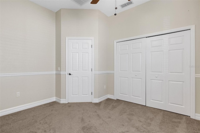 unfurnished bedroom featuring ceiling fan, light carpet, and a closet