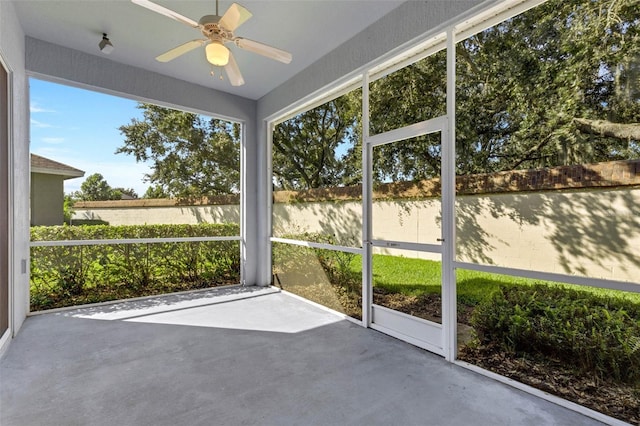 unfurnished sunroom featuring ceiling fan