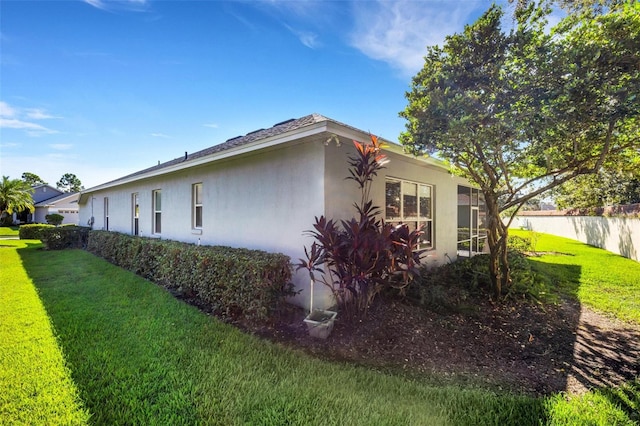 view of side of home featuring a lawn