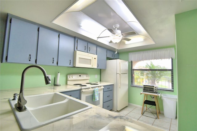 kitchen featuring light tile patterned flooring, sink, white appliances, ceiling fan, and blue cabinetry