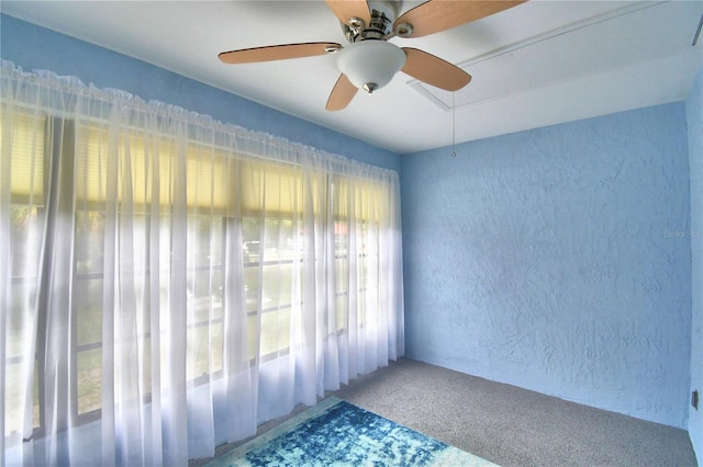 unfurnished room featuring carpet floors and ceiling fan