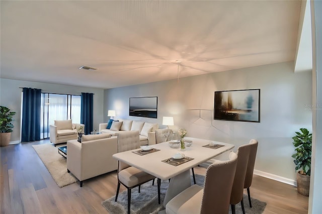 dining area with hardwood / wood-style flooring