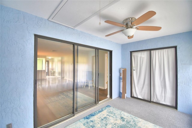 interior space with ceiling fan, a closet, and carpet flooring