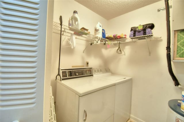 washroom featuring a textured ceiling and separate washer and dryer