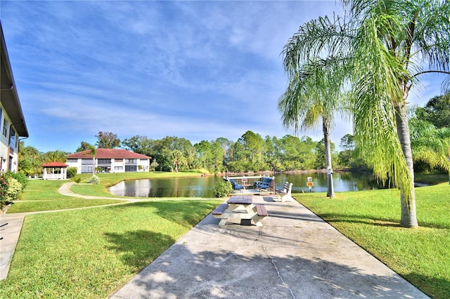 view of community with a yard and a water view