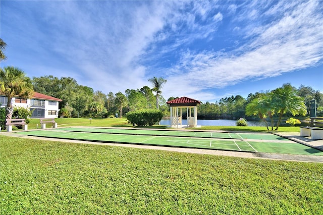 view of property's community featuring a lawn, a water view, and a gazebo