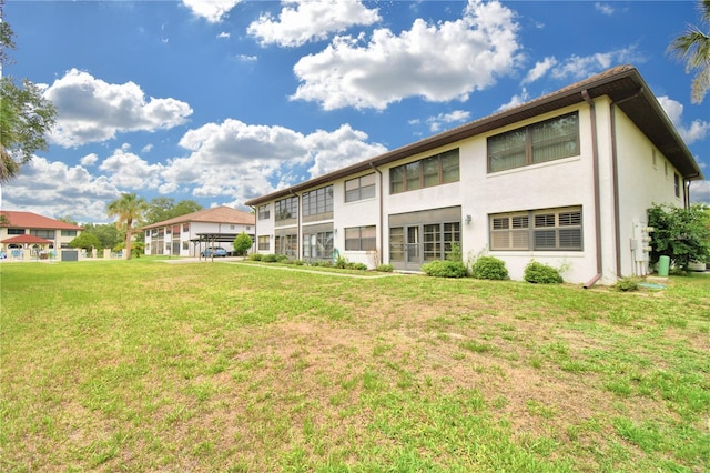 rear view of house with a lawn