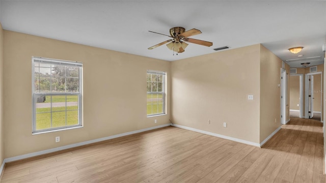 spare room featuring light hardwood / wood-style flooring and ceiling fan