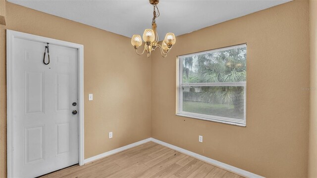 interior space featuring an inviting chandelier and hardwood / wood-style flooring