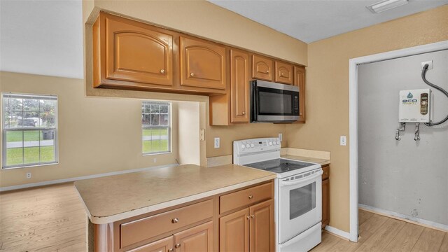 kitchen with white range with electric stovetop and light hardwood / wood-style floors