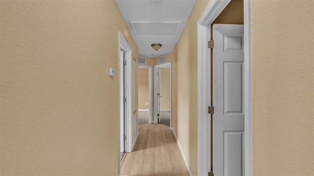 corridor with light hardwood / wood-style floors