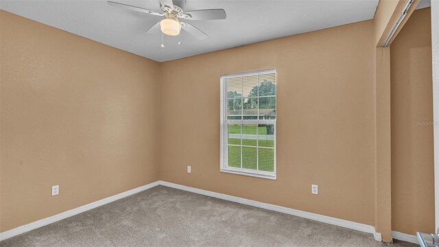 unfurnished room featuring light carpet and ceiling fan