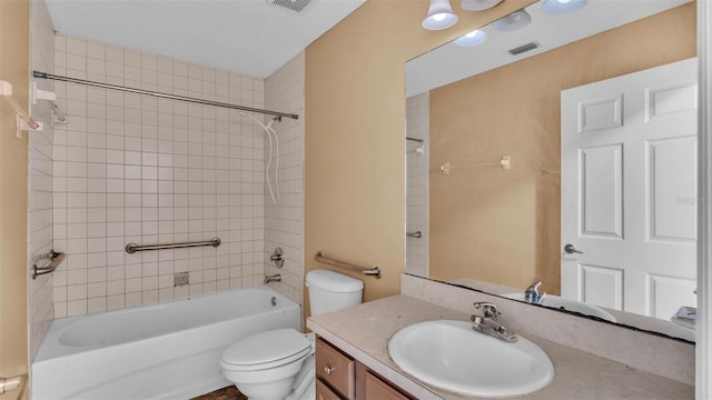 full bathroom featuring tiled shower / bath, toilet, and vanity