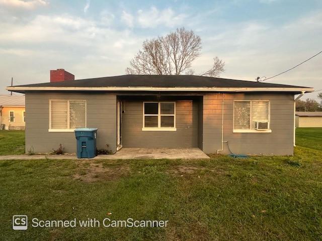 back of house featuring cooling unit, a lawn, and a patio area