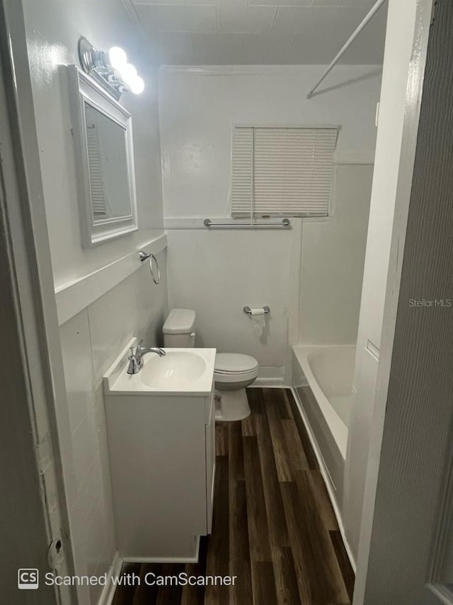 full bathroom featuring vanity, toilet, hardwood / wood-style flooring, and shower / bathing tub combination